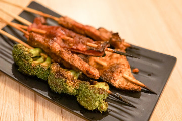 Grilled fish cake, broccoli, smoked beef, tofu skin on sticks street food delicious cuisine