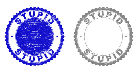 Grunge STUPID stamp seals isolated on a white background. Rosette seals with grunge texture in blue and gray colors. Vector rubber stamp imitation of STUPID text inside round rosette.