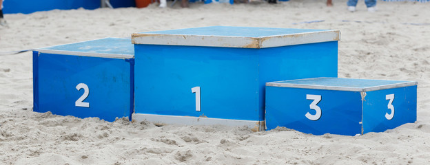 Winner, podium in the sand, sporting on the beach