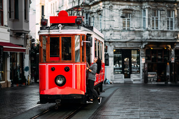 Girl in a vintage tram on the Taksim Istiklal street in Istanbul. Girl on public transport. Old...