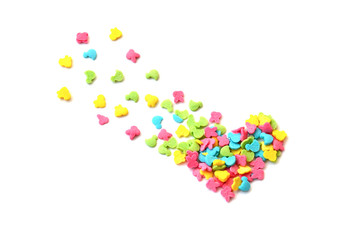 Isolated bright multi-colored heart and small pieces from sweet confectionery topping flying