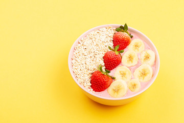 Smoothie bowl on yellow background