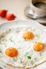 Fried egg. Close up view of the fried egg on a white plate. Light morning Breakfast, fresh warm pastries and aromatic cappuccino coffee
