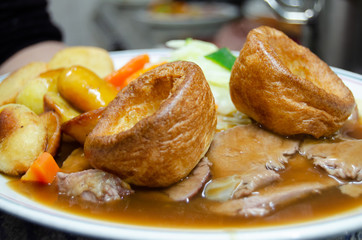 close up of plate with slow cooked beef with potatoes carots and vegetables in sauce