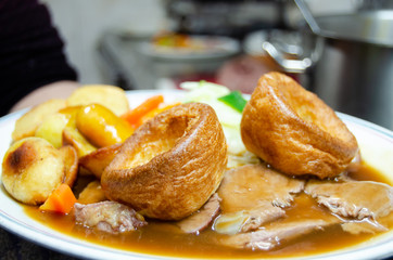 close up of plate with slow cooked beef with potatoes carots and vegetables in sauce