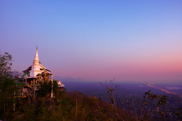 The pagoda of the Thai temple on the top of the mountain during dawn.Thai temple name Wat Phra Phutthabat Pha Nam at Li city Lamphun,Thailand