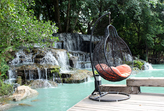 rattan swing chair on waterfront