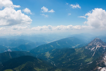 On peak of Dachstein and view alpine mountains