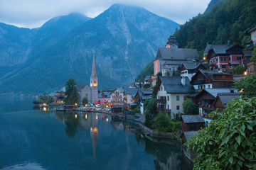 Fototapeta premium View of Hallstatt village with lake. Far away beauty Alpine rocks and blue sky