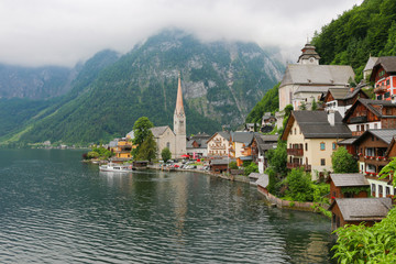Naklejka premium View of Hallstatt village with lake. Far away beauty Alpine rocks and blue sky