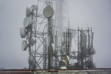Tower with radio antennas in the fog. Tiger Hill near the town of Darjelling. India