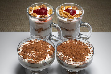 Curd dessert Tiramisu in a glass container of different shapes.