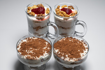 Curd dessert Tiramisu in a glass container of different shapes.