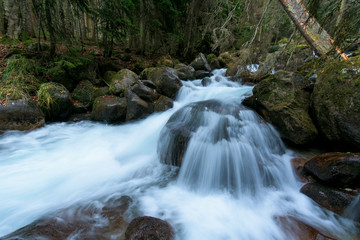 river in the mountains. mountainous area. photo on a long exposure, cloudy day.  waterfalls in the mountains in the forest