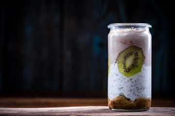 Homemade heathy dessert layered in jar with chia seeds