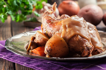 Stewed rabbit legs with vegetables