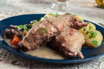 Stewed rabbit legs with vegetables