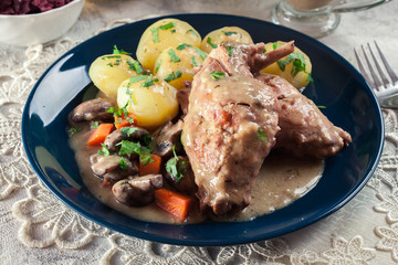 Stewed rabbit legs with vegetables