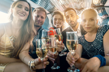 Crowd of party people in a limo with drinks