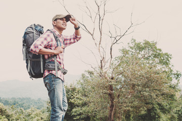 Hiking man traveling with backpack in mountains