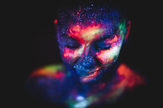 Portrait of a girl painted in fluorescent UV colors.