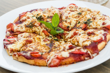 Strawberry pizza on a white plate