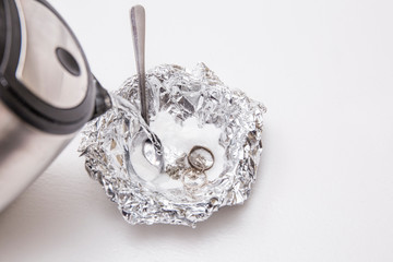 A solution of baking soda(Sodium bicarbonate) and warm water will remove the tarnish from silver...