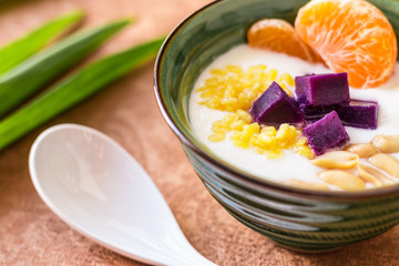 Yogurt in a green bowl with a spoon