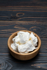 Traditional Mascarpone cheese in wooden bowl on table
