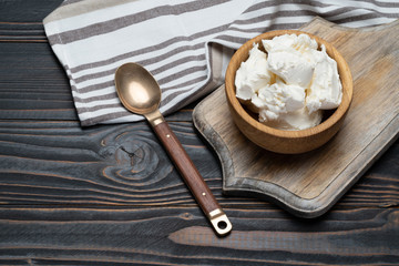 Traditional Mascarpone cheese in wooden bowl on table