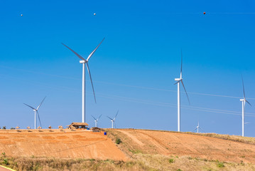Power of wind turbine generating electricity clean energy with cloud background on the blue sky.Global ecology.Clean energy concept save the world.