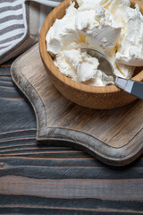 Traditional Mascarpone cheese in wooden bowl on table