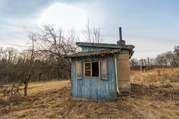old abandoned cabin on a meadow