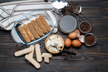 Ingredients for making traditional italian cake tiramisu on wooden table