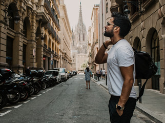 Traveler male looking on a big europe city, travel and active lifestyle concept.Bearded Tourist Man with black leather bag enjoy beautiful city travel