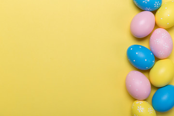 Fototapeta na wymiar easter eggs on yellow pastel color background with space. Concept