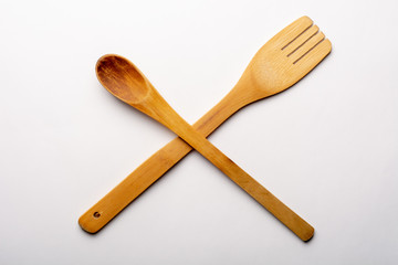 Vintage Wooden Spoon and Fork on White Textured Paper. Kitchen and Cooking Concept.