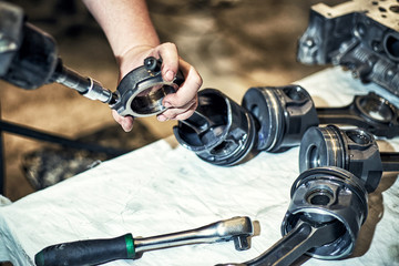 Automotive four-cylinder engine water cooling during repair.