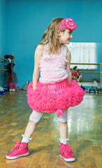 Little funny, bullying, mischievous girl dancing in a dance class