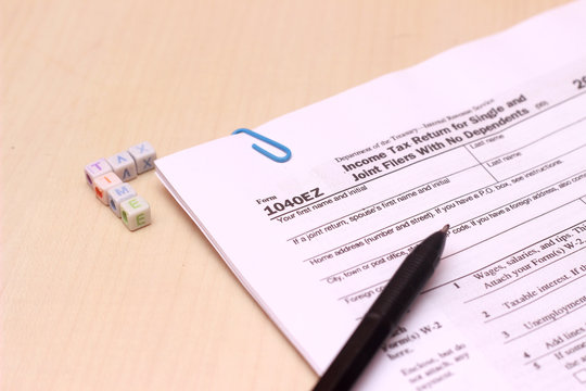 Close Up Of Usa Tax Form Type 1040ez, Income Tax Return For Single And Joint Filers With No Dependents At Wooden Table