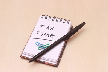 Illustration for Tax Time, block note at wooden table
