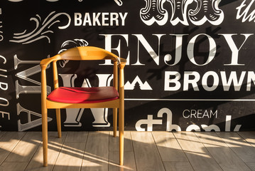 Red chairs on a wooden floor black, elegant piece of interior of restaurant.