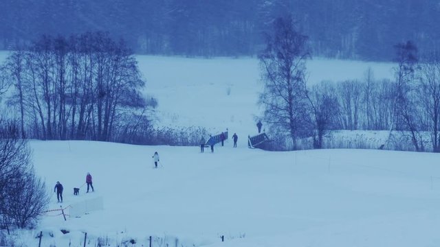 A lot of people ski running on blizzard in Norway