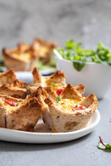 Egg muffins with peppers in a toast cup for breakfast brunch.