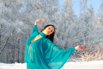 Girl dancing on the background of a winter landscape.