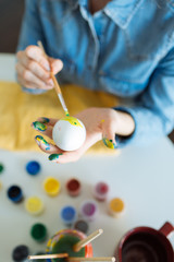 Girl paints eggs