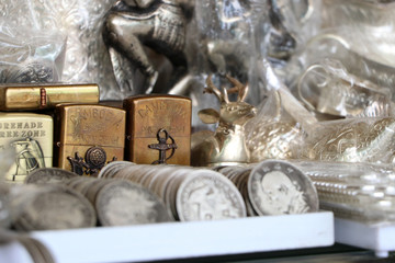 Brass lighters placed among many silver.