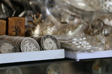 Antique money placed among many silver for sell as souvenirs in Cambodia.