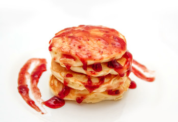 Pancakes with strawberry jam white plate