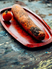 Freshly whole carrots on old wooden table